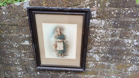 Vintage photo sepia of young woman, in dark wood vintage glazed frame