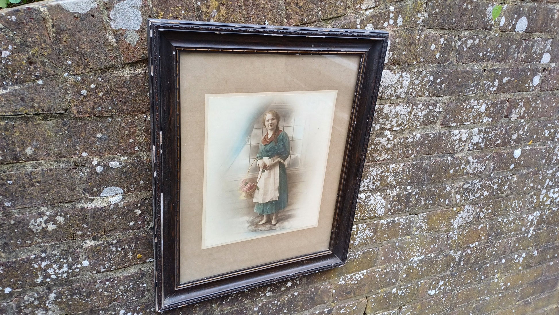 Vintage photo sepia of young woman, in dark wood vintage glazed frame