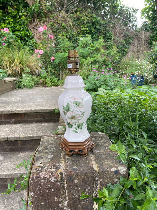 late 70s, early 80s oriental style, chineseceramiclamp. Standing on a carved resin base. Complete with painted flowers - cherry blossoms. smaller than many lamps in this style. white with flowers. excellent condition