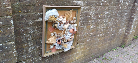 magnificent 3D collage craft picture of shells, material, plants, string, coral attached to a hessian backing. Presented in a wonderful upcycled vintage frame of blue and gold. A true work of art.