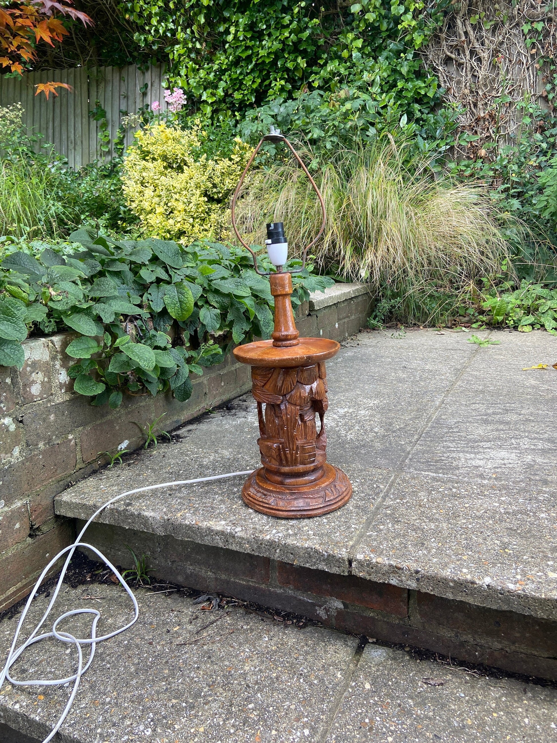 large ethnic carved wooden lamp. possibly from south pacific or asia. plants houses and person engraved. Large. working