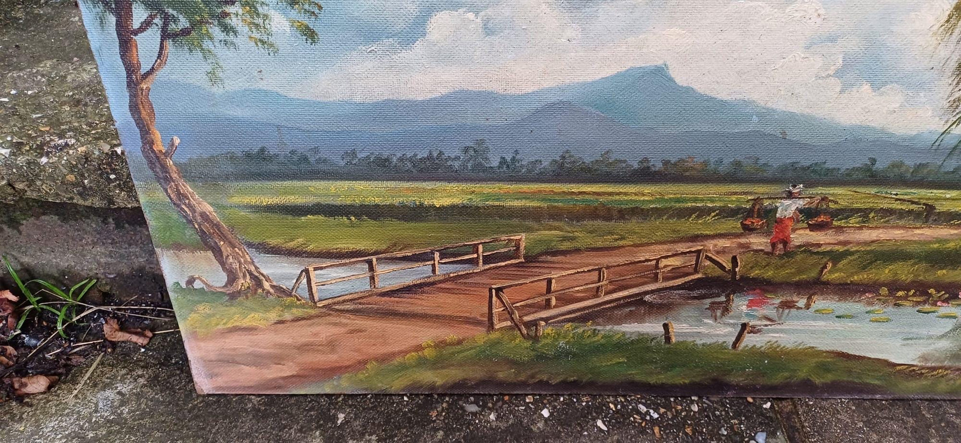 1960s oil on board by artist Yusoff Abdullah. Rural scene of a villager / farmer carrying goods across a field. Signed painting