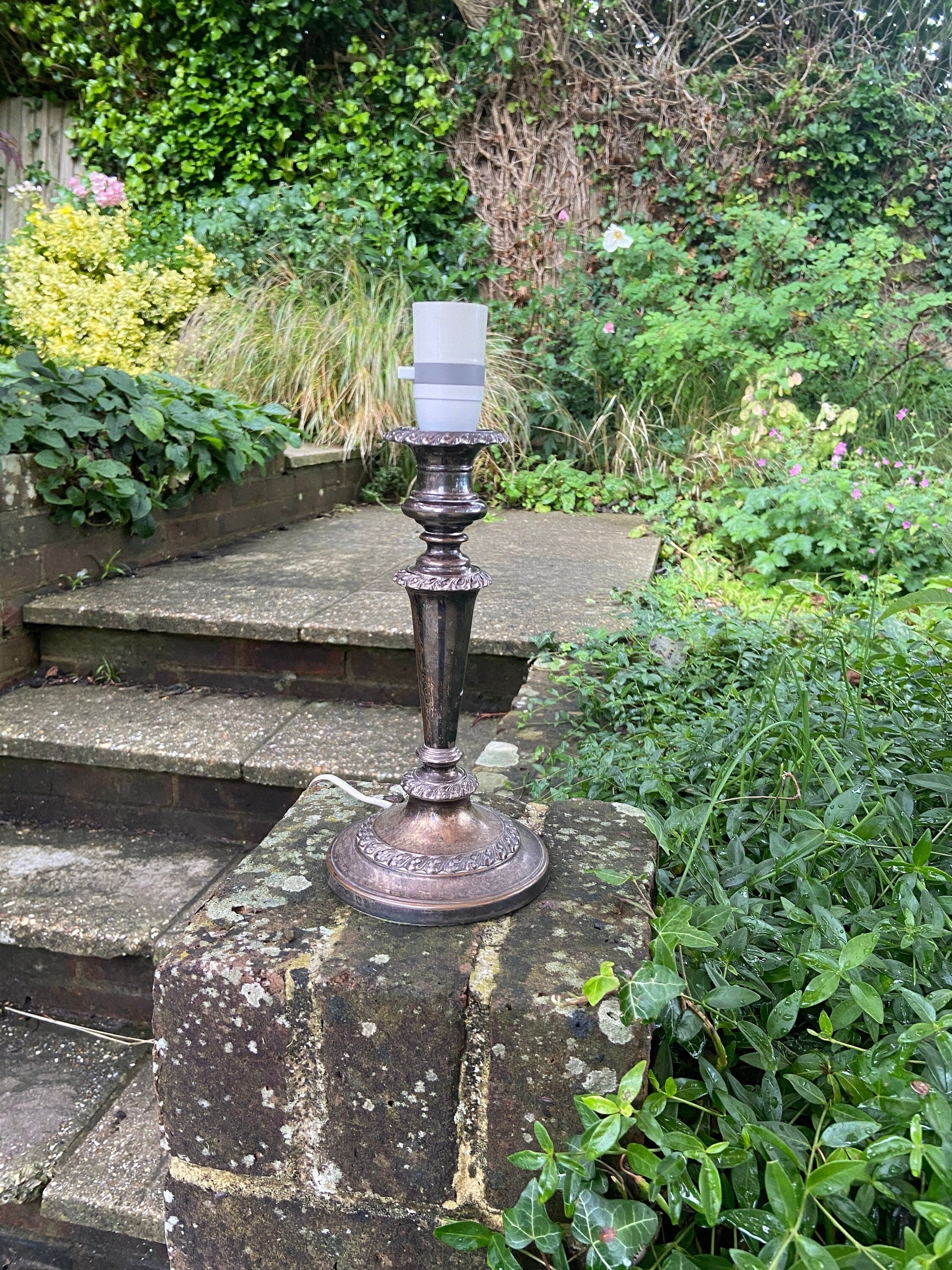 silver plate candlestick holder style table lamp. Ornate. may even have beena candlestick holder in a previous life. Working condition.