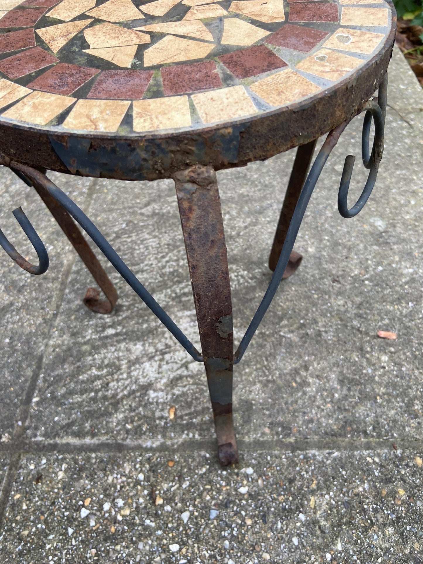 larger wrought iron table with a mosaic top. perfect as a side table, outdoortable or plant stand. rusted finish. solid and heavy