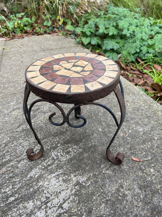small wrought iron table with a mosaic top. perfect as a side table, outdoortable or plant stand. rusted finish. solid and heavy