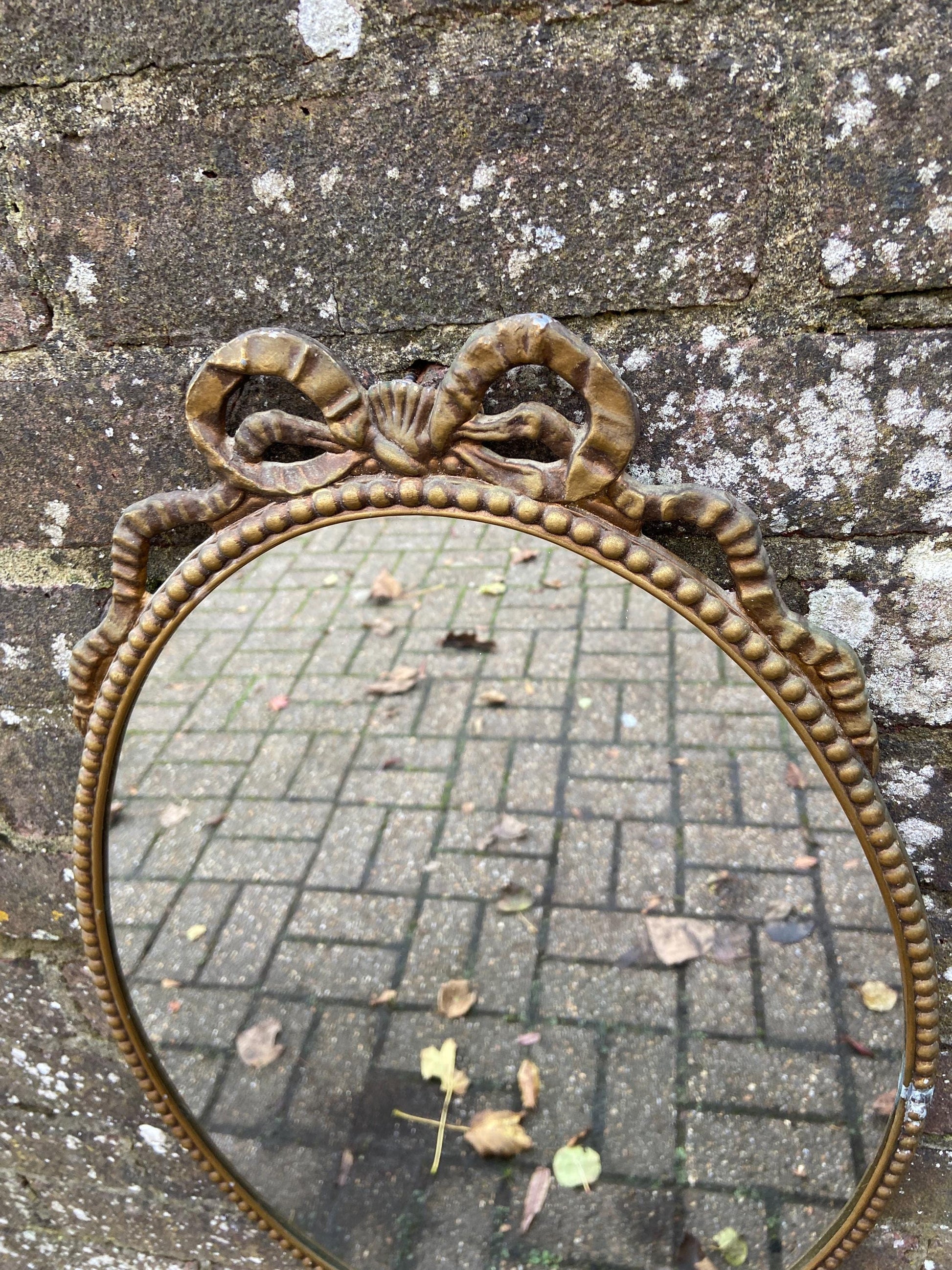 Delightful ornate vintage gilt metal framed oval mirror