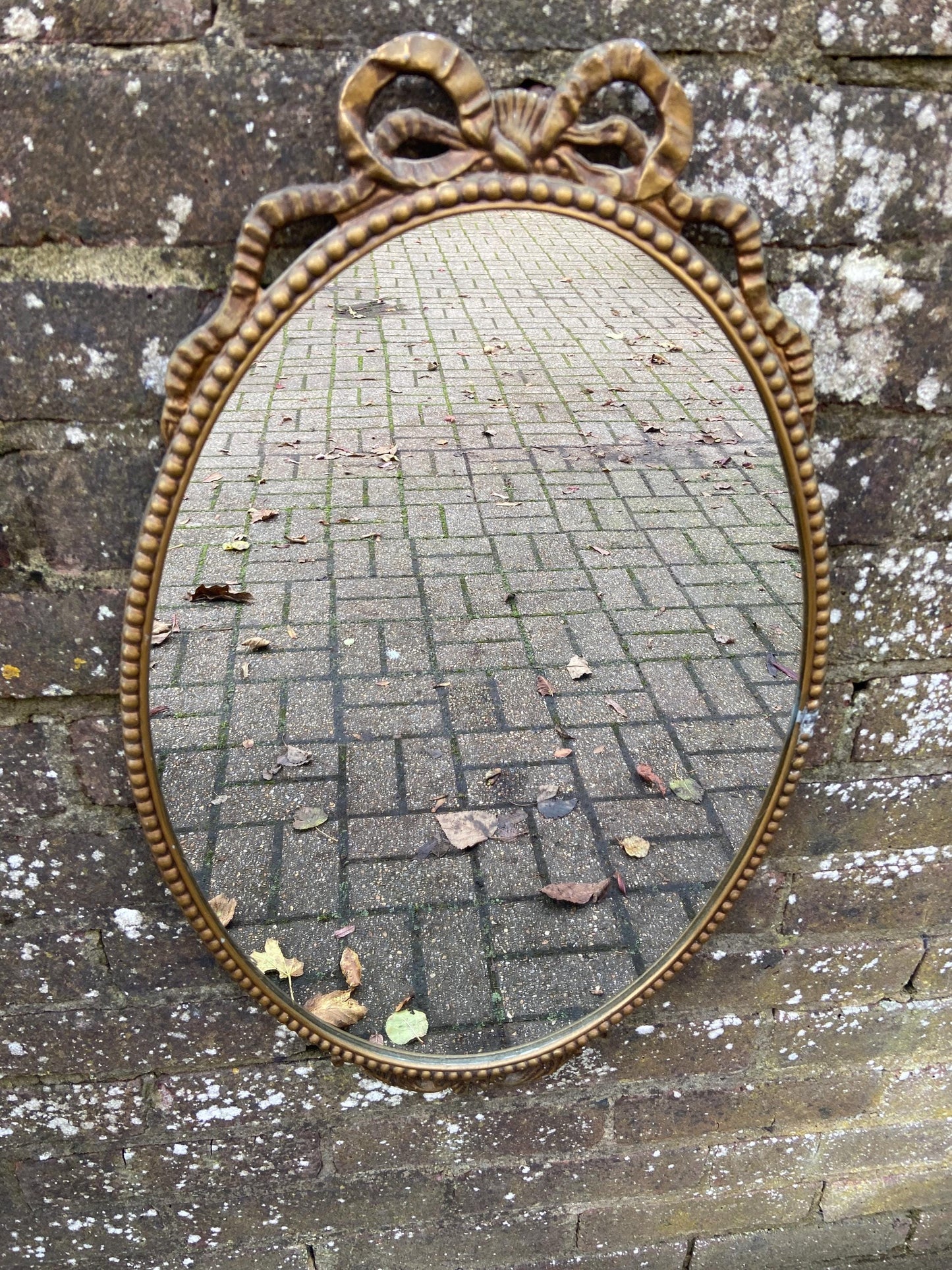 Delightful ornate vintage gilt metal framed oval mirror