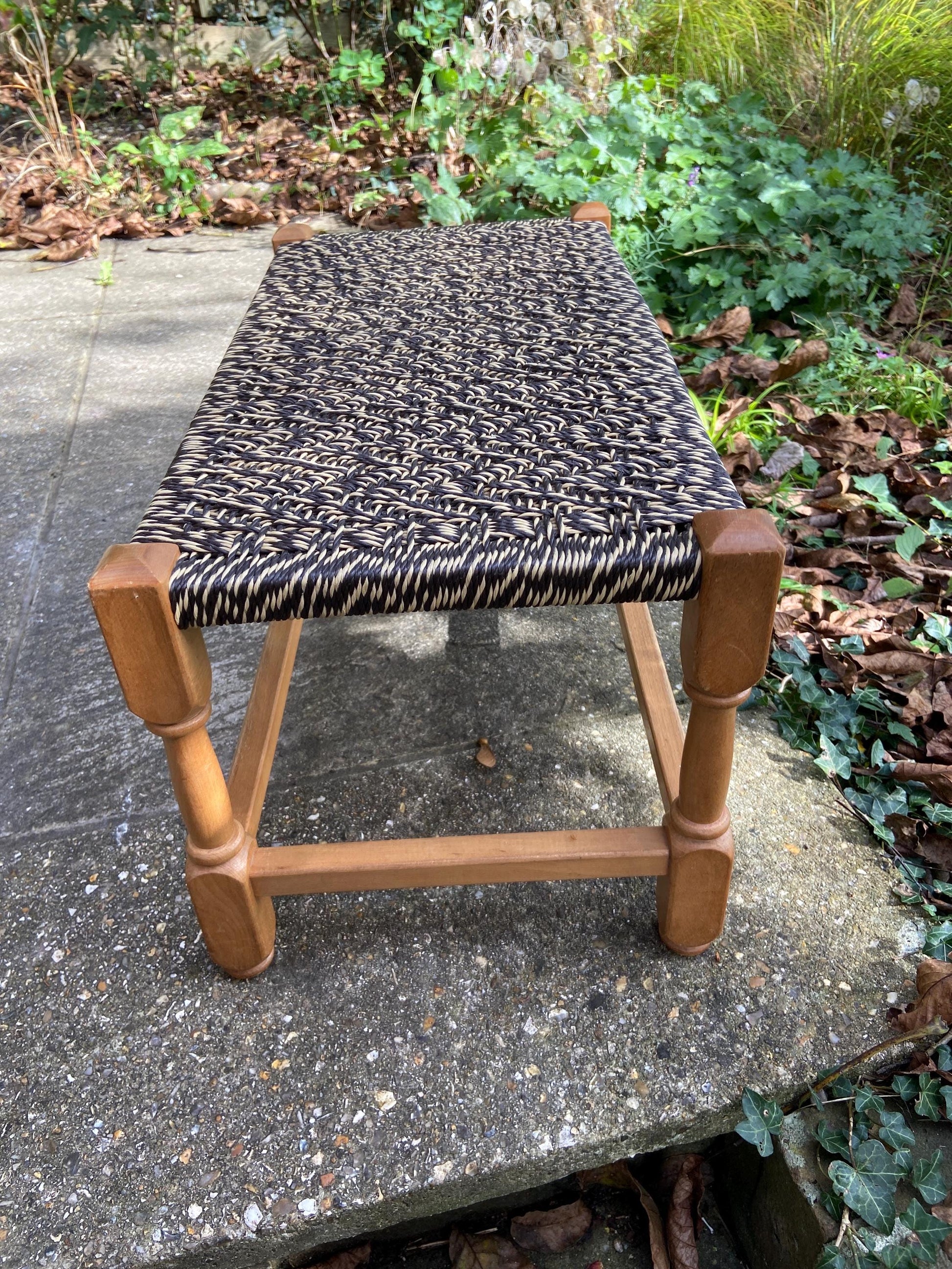 Retro strung string stool – excellent condition, black and white plastic string criss-cross on light coloured wooden frame