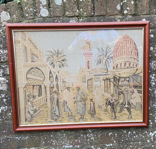 1930s vintage tapestry of north african town scene. framed in a 1990s glazed wooden frame. wonderful town scene depiction