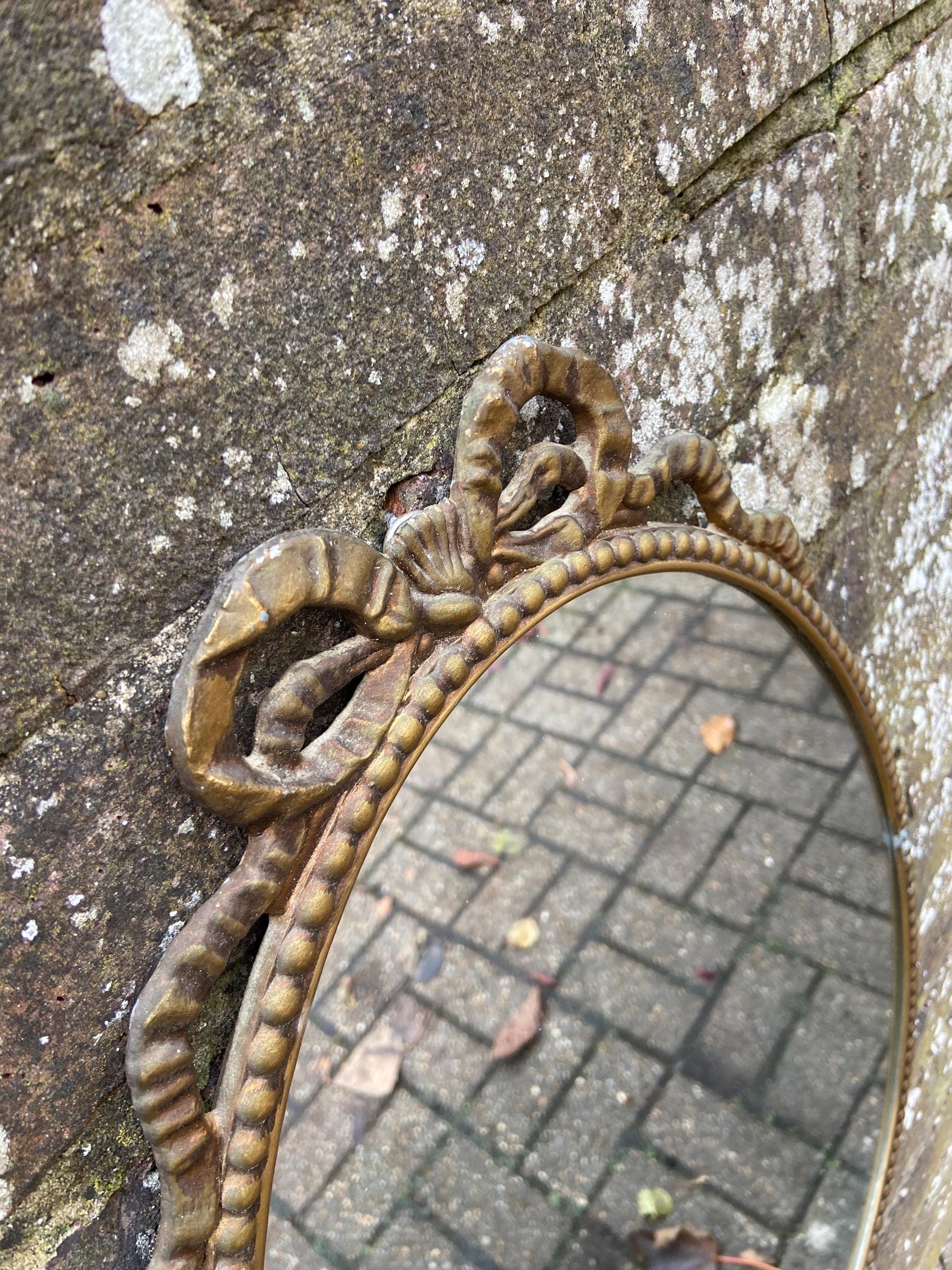 Delightful ornate vintage gilt metal framed oval mirror