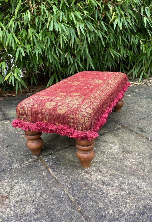 rectangular upholstered foot stool on wooden legs. red tapestry type material. vgc