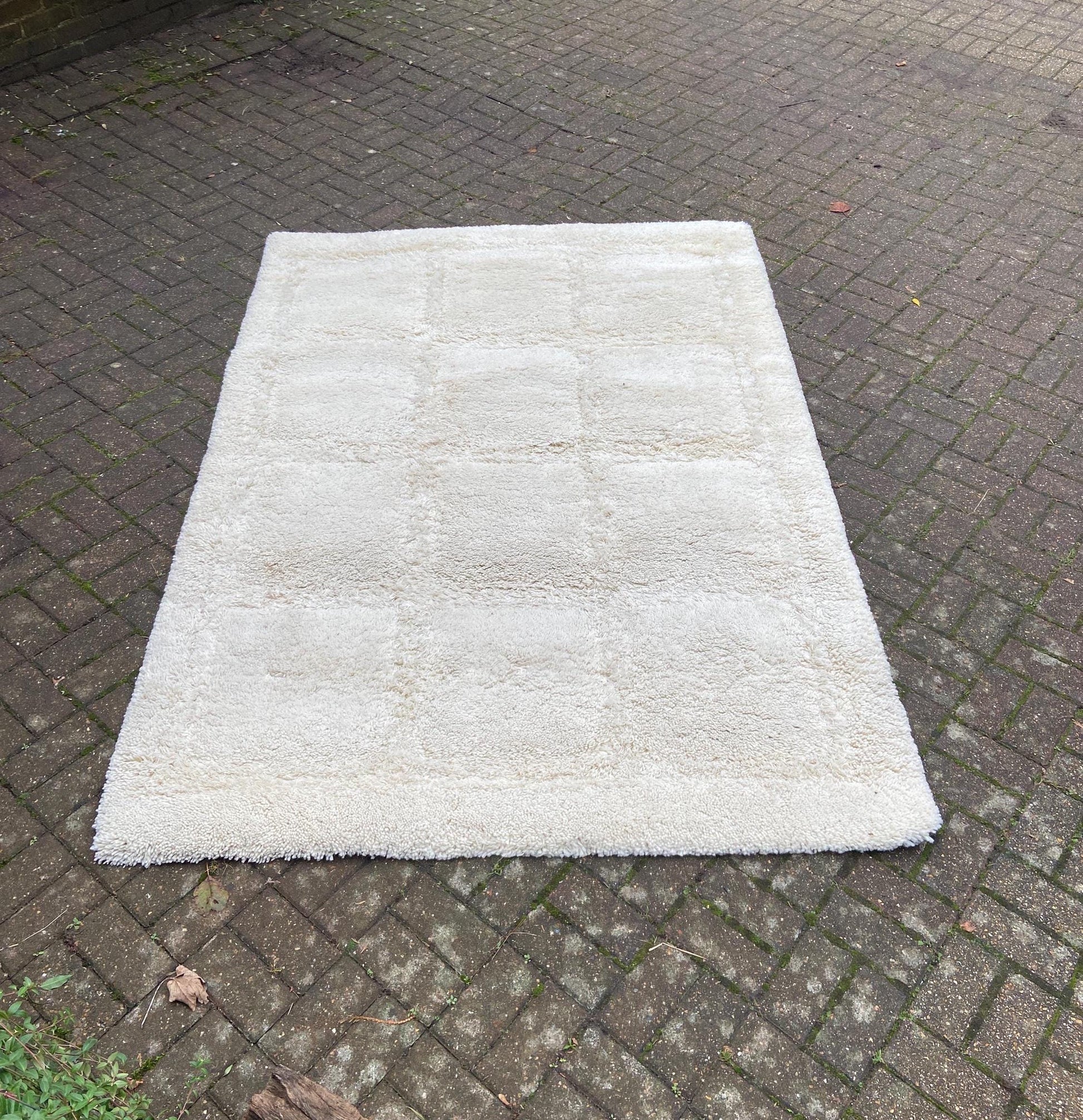 large shaggy cream rug with square contrasting detail; late retro