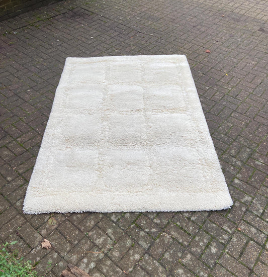 large shaggy cream rug with square contrasting detail; late retro