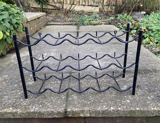 wall or surface mounted plastic and metal black wine rack from the 1970s. retro wine rack. 10 or 15 bottles