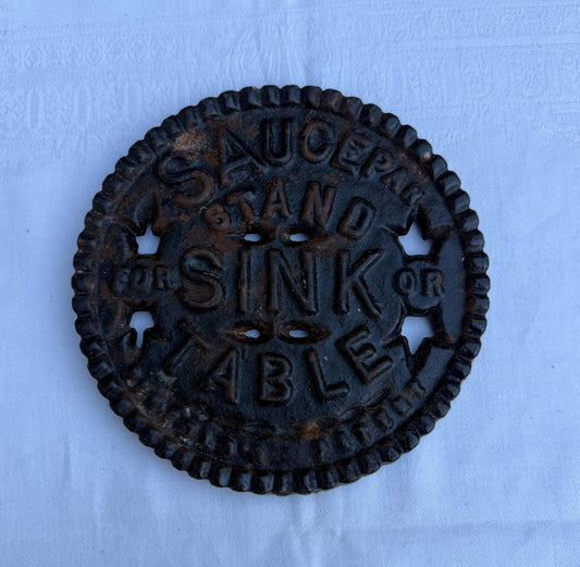 pot trivet in heavy black iron - industrial look. kitchen saying &quot;saucepan stand forsink or table&quot;