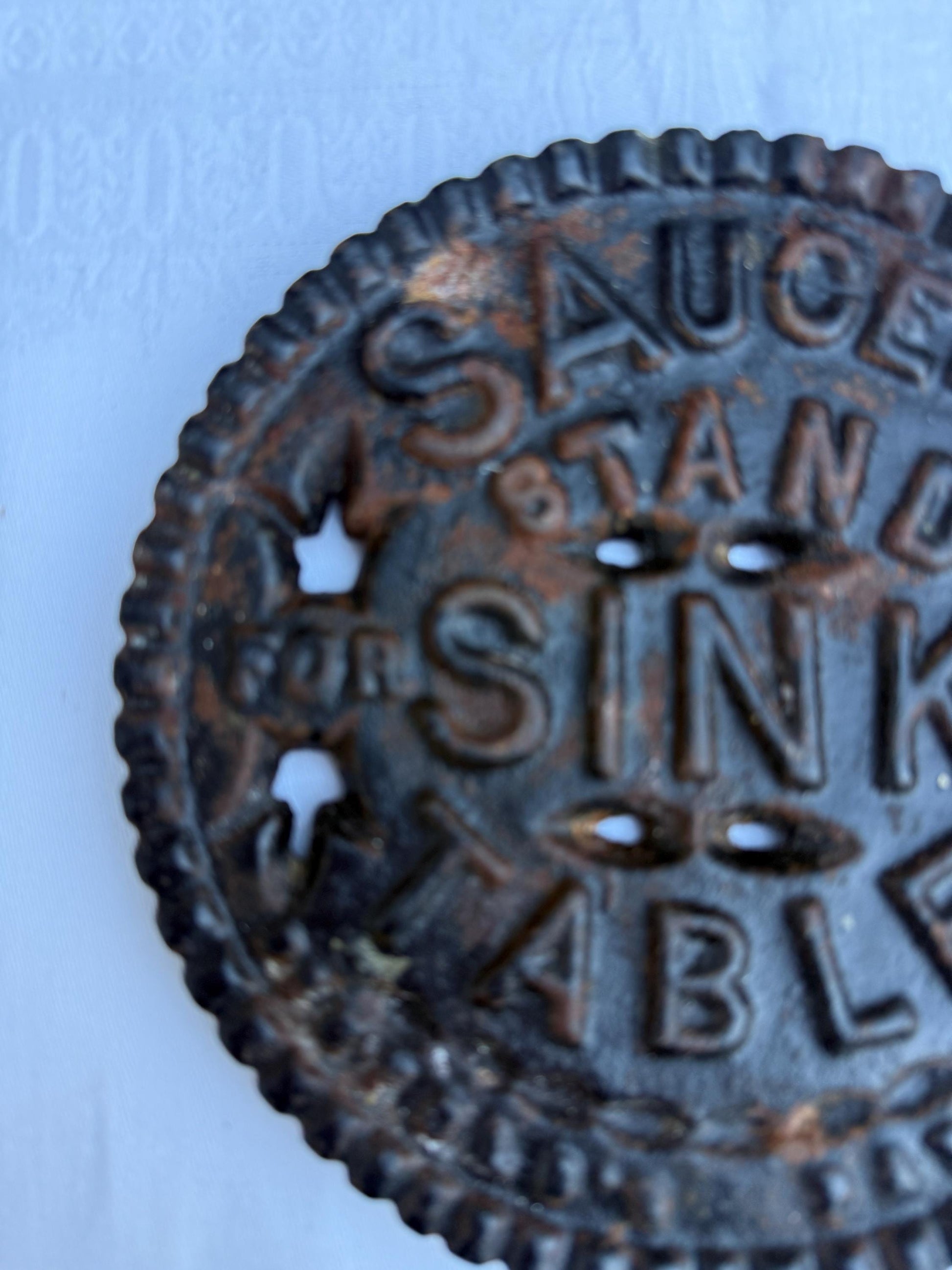 Fantastic heavy iron tivert or pot stand with wording "Saucepan stand for sink or table" - great for kitchens and tables 17cm wide