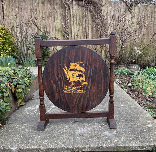 small wooden fire screen or fire guard.  early to mid 1900s.  wooden frame with painted galleon.