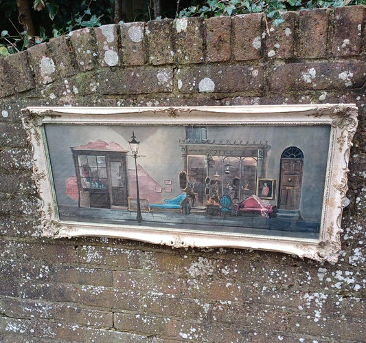 wonderful quirky print of an original oil painting by Deborah Jones of a back street antique shop.  Delightfully framed in a retro gesso frame. glazed print. Ready to hang