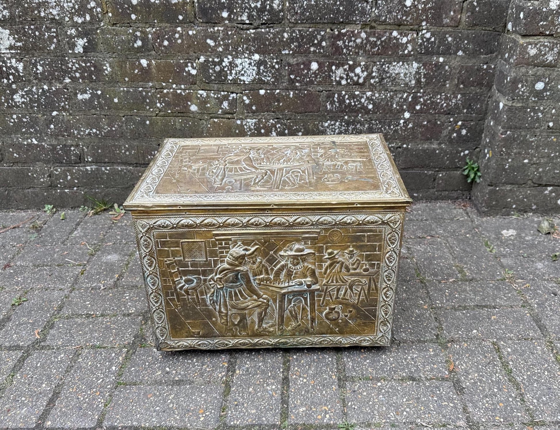 mid century coal box, wooden box covered in embossed and moulded beaten brass. medieval gothic style of coal box.