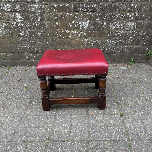 mid century solid oak stool with red leather top.