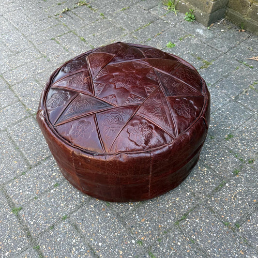 brown leather pouf. retro in age. lovely pattern top. beanbag filling.