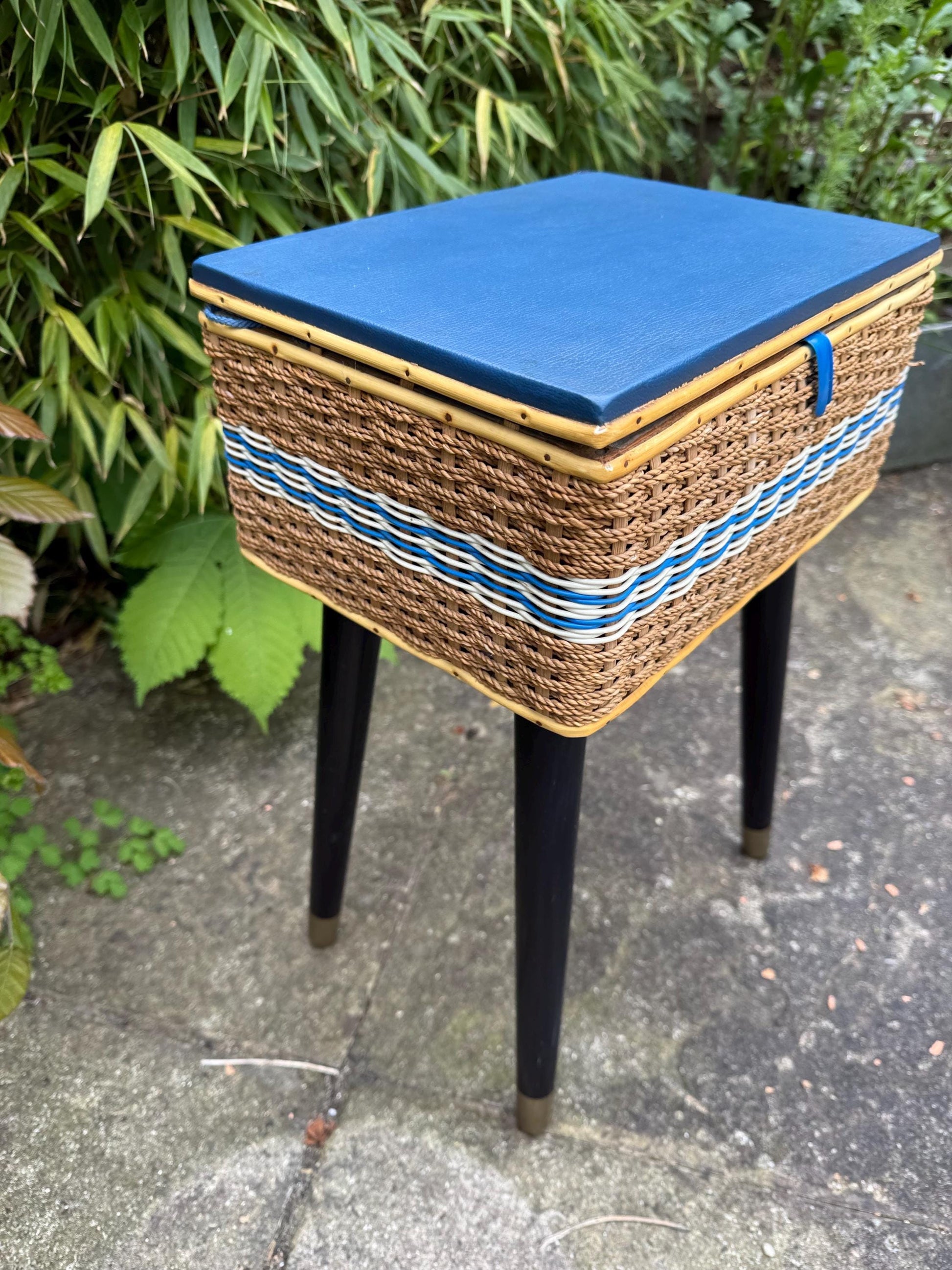 Vintage mid-century wicker sewing box on metal capped tapered legs, retro craft storage, with blue lid and metal tipped legs, 1950s workbox
