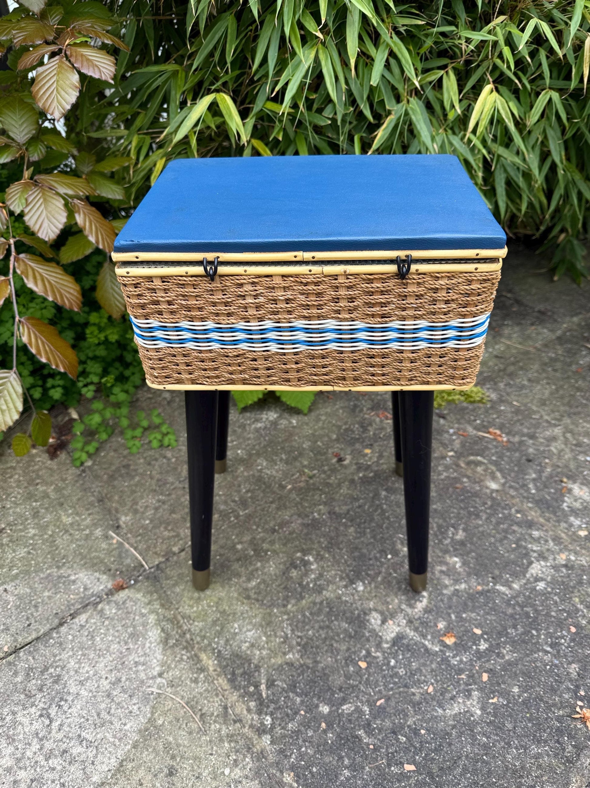 Vintage mid-century wicker sewing box on metal capped tapered legs, retro craft storage, with blue lid and metal tipped legs, 1950s workbox