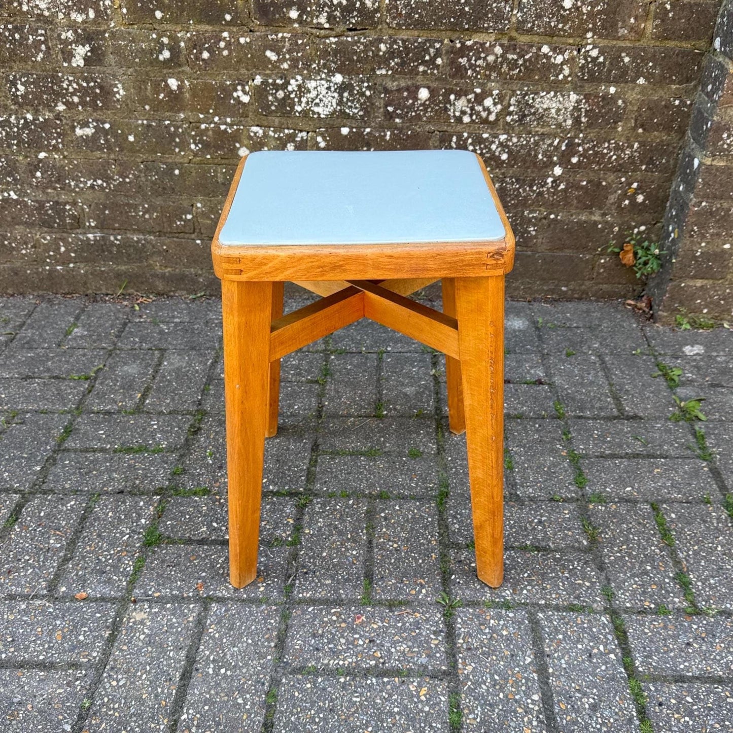 mid century beech stool with vinyl top. light golden wood with light grey blue seat. mid-century scandi influenced stool with tapered splayed legs