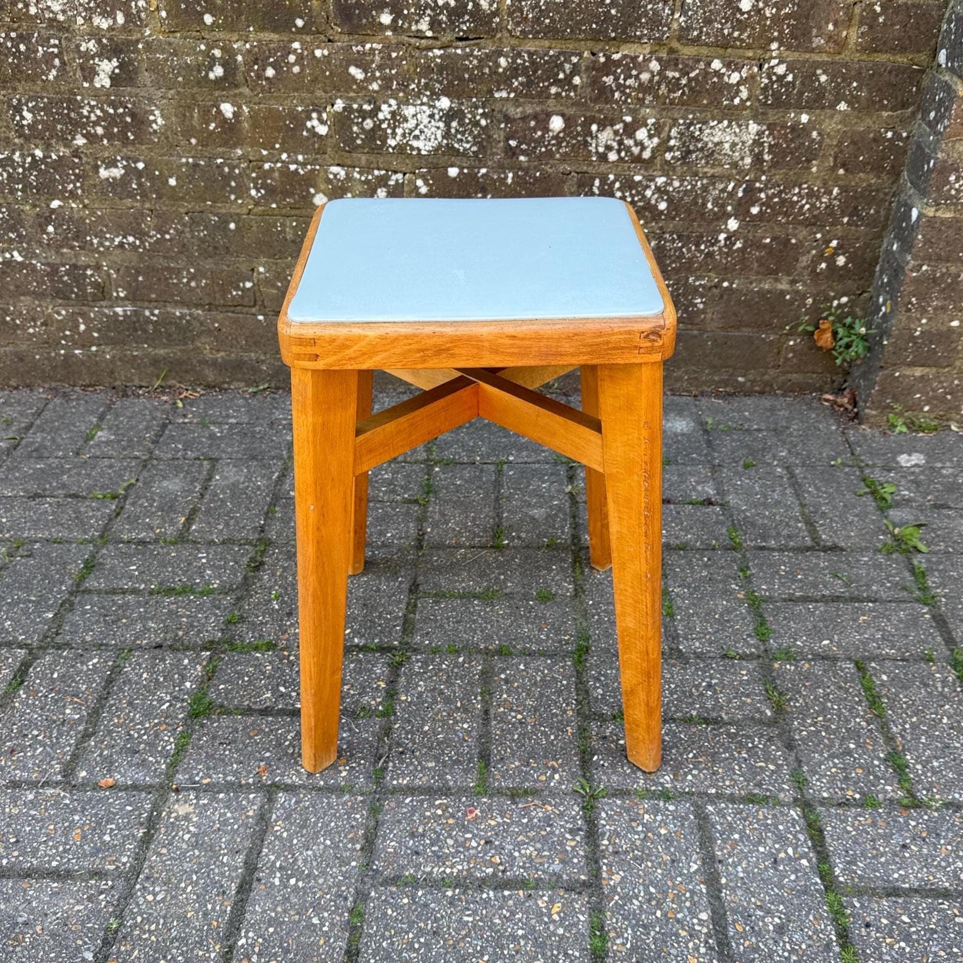 mid century beech stool with vinyl top. light golden wood with light grey blue seat. mid-century scandi influenced stool with tapered splayed legs