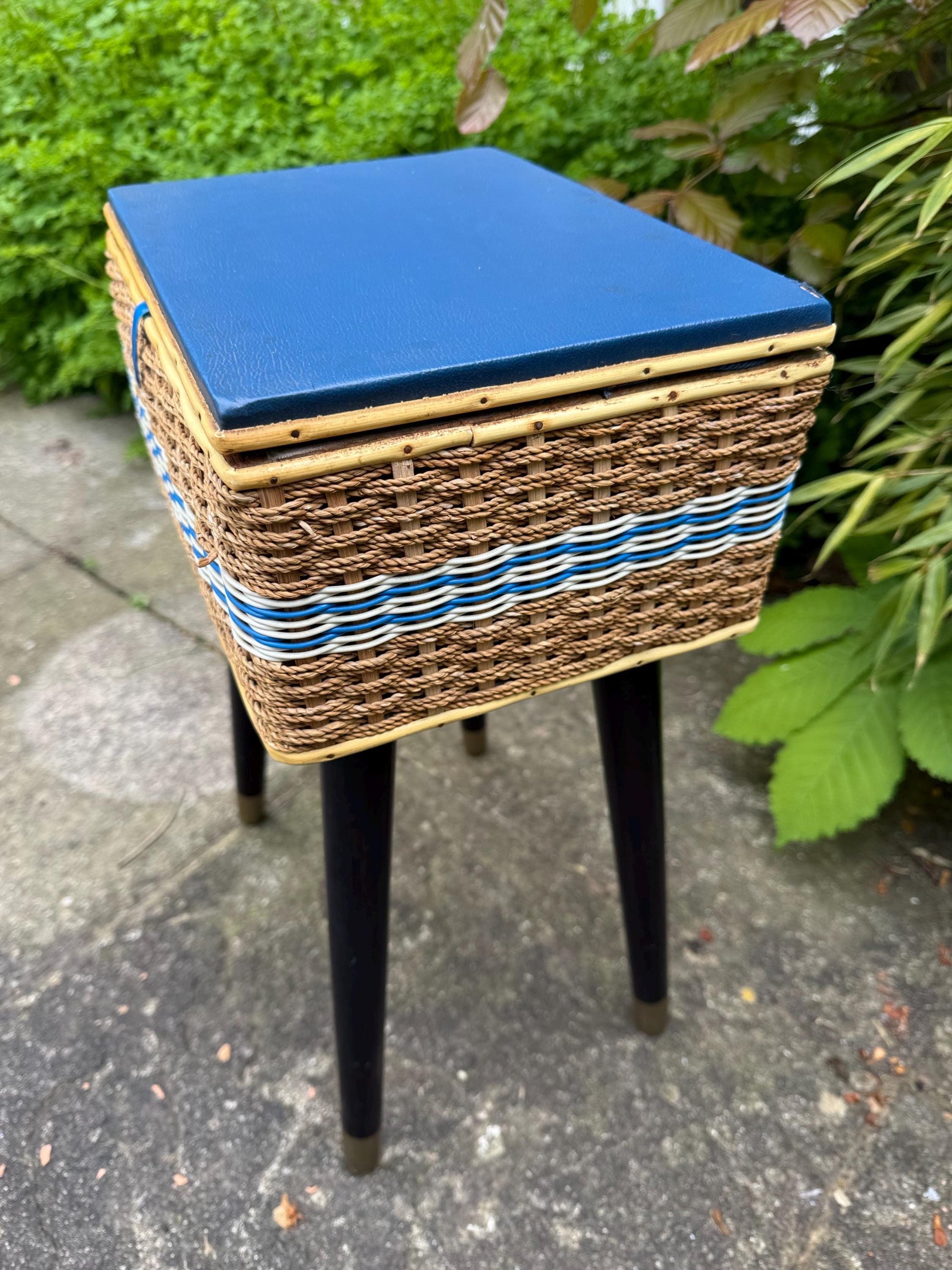 Vintage mid-century wicker sewing box on metal capped tapered legs, retro craft storage, with blue lid and metal tipped legs, 1950s workbox