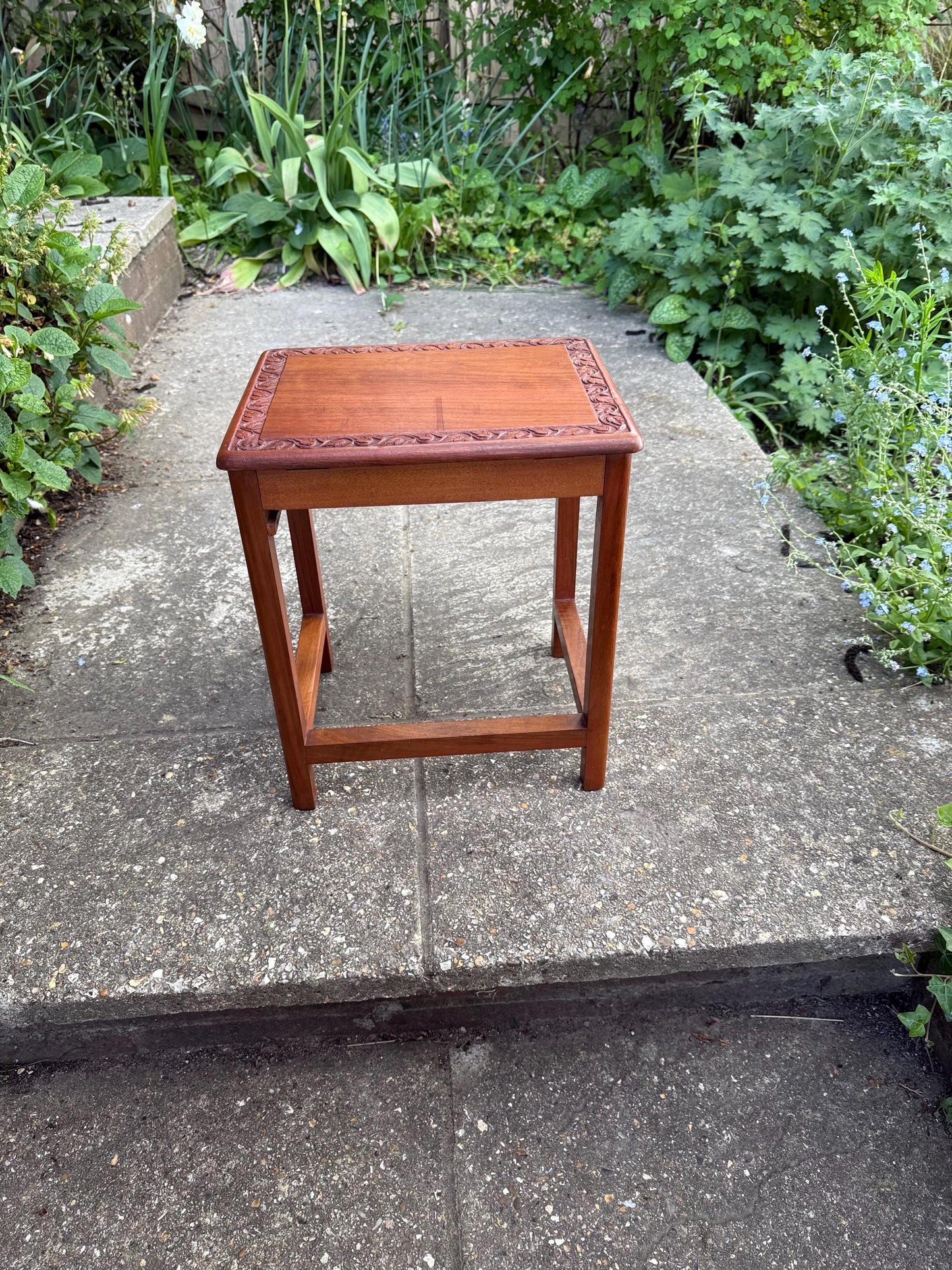 small hand carved wooden table with leaf detail. mahogany coloured table with a secret compartment. 1950s early retro, mid century shaped table. could be plant stand
