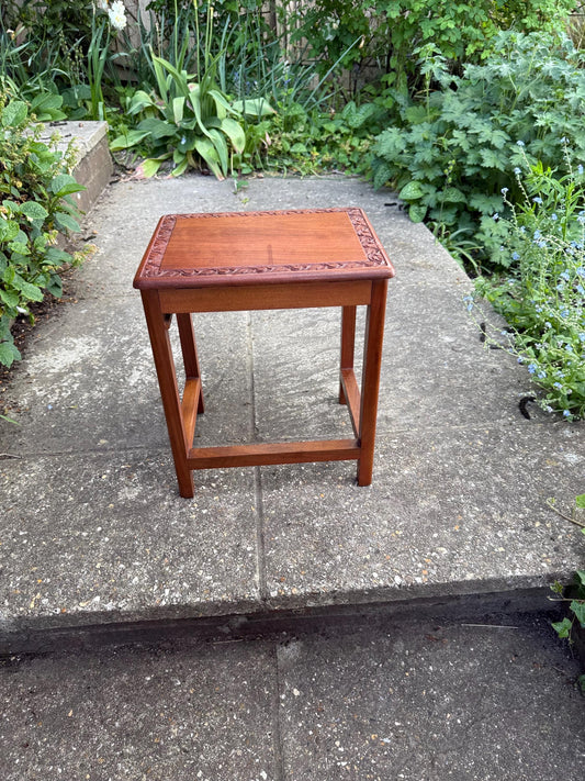 small hand carved wooden table with leaf detail. mahogany coloured table with a secret compartment. 1950s early retro, mid century shaped table. could be plant stand
