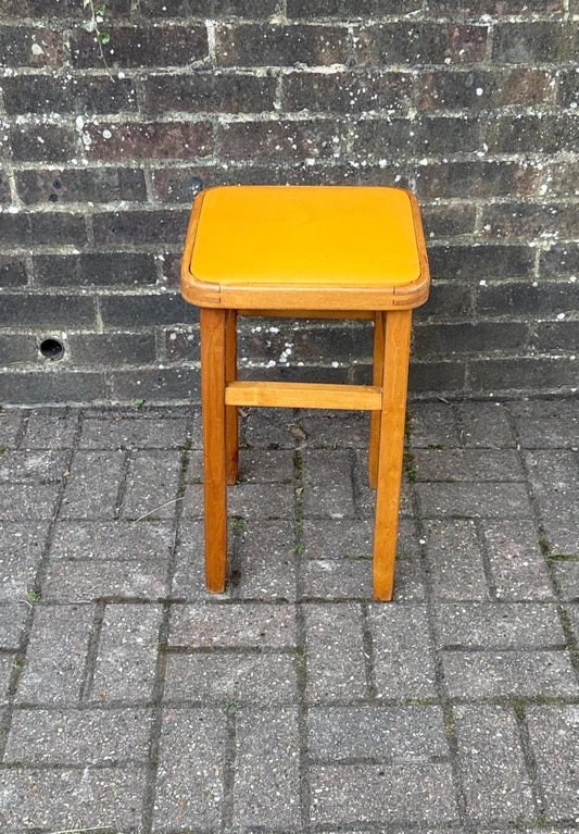 bright yellow po retro wooden stool. likely beech stool with vinyl top. great vintage condition