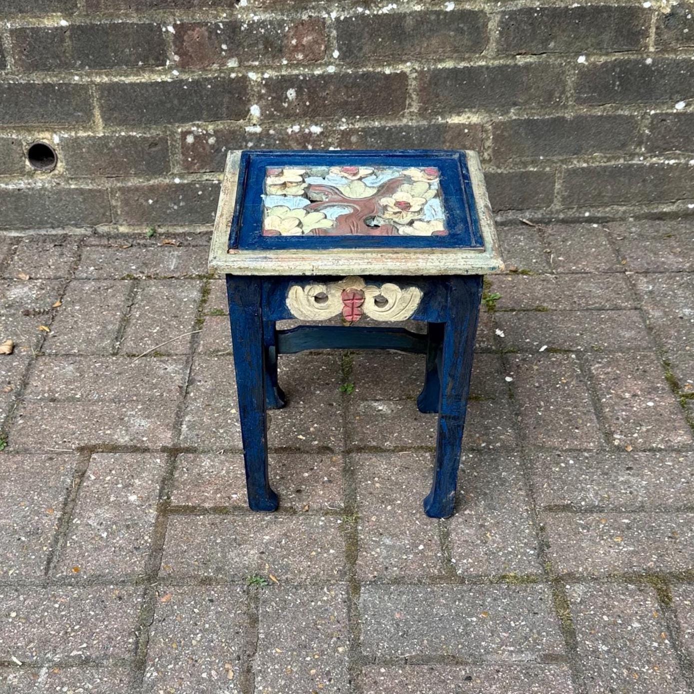 boho chic, hand painted and carved small wooden table in bold and beautiful colours. cobalt blue shabby chic finish on the frame. pastel colours on the top woodland detail. side carvings which look like owl faces, but are not.  rustic and unusual, possibly european.