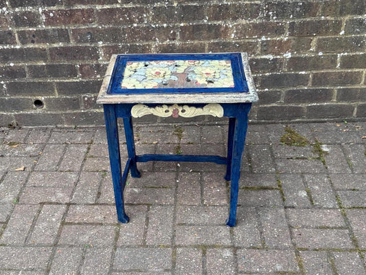 boho chic, hand painted and carved small wooden table in bold and beautiful colours. cobalt blue shabby chic finish on the frame. pastel colours on the top woodland detail. side carvings which look like owl faces, but are not.  rustic and unusual, possibly european.