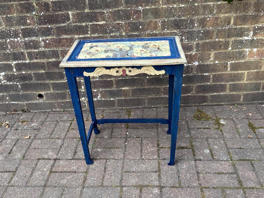 boho chic, hand painted and carved small wooden table in bold and beautiful colours. cobalt blue shabby chic finish on the frame. pastel colours on the top woodland detail. side carvings which look like owl faces, but are not.  rustic and unusual, possibly european.