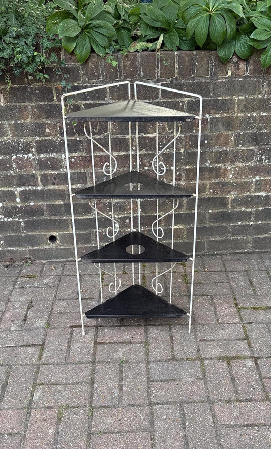 vintage mid century 1950s black and white metal and iron shelves. lovely as a plant stand or garden shelving. white scrollwork iron stand with metal black triangular shelves. corner vintage standing shelves