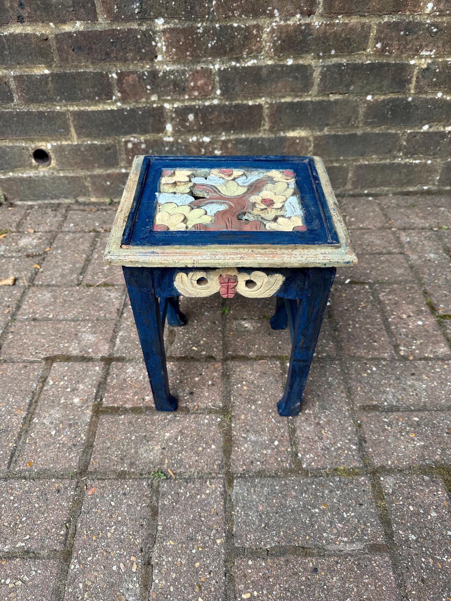 boho chic, hand painted and carved small wooden table in bold and beautiful colours. cobalt blue shabby chic finish on the frame. pastel colours on the top woodland detail. side carvings which look like owl faces, but are not.  rustic and unusual, possibly european.