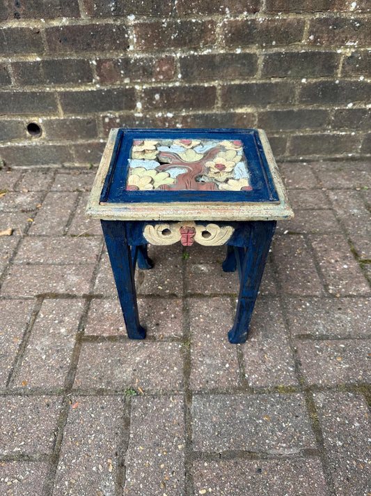 boho chic, hand painted and carved small wooden table in bold and beautiful colours. cobalt blue shabby chic finish on the frame. pastel colours on the top woodland detail. side carvings which look like owl faces, but are not.  rustic and unusual, possibly european.