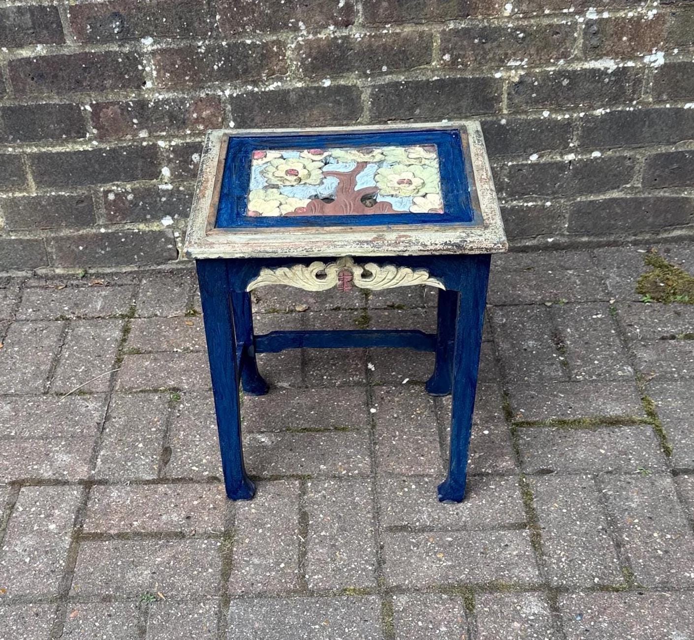 boho chic, hand painted and carved small wooden table in bold and beautiful colours. cobalt blue shabby chic finish on the frame. pastel colours on the top woodland detail. side carvings which look like owl faces, but are not.  rustic and unusual, possibly european.
