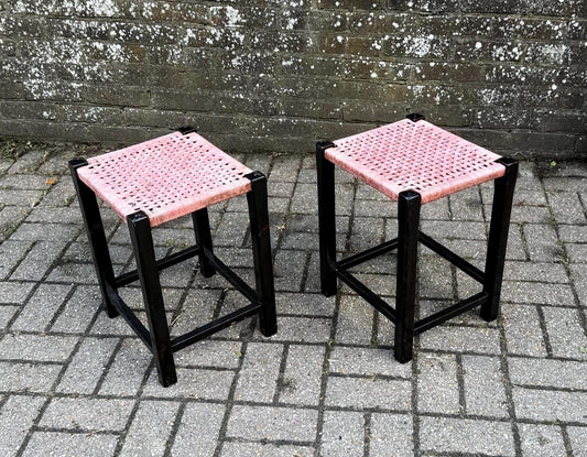 mid century pair of wooden stools with woven seats. pink and black. decent condition faded pink seats, some scuffing to paintwork