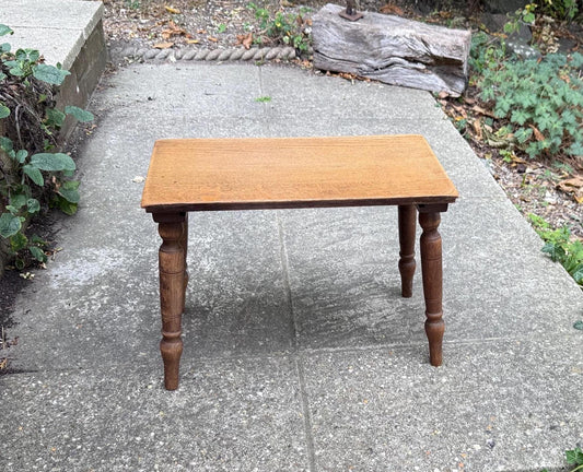 small oak occasional table. splayed turned dark oak legs. sanded and lighter coloured smooth oak top.  rectangular shape. small for side table use