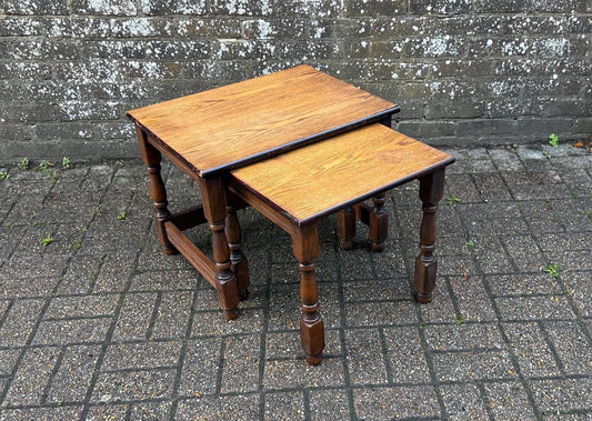 nest of two solid wooden tables. stripped and sanded tops now oiled. dark stained turned wooden leg and bases. two tone tables. nearly fitted nest