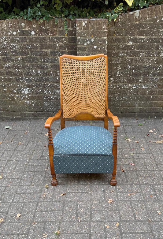 stylish mid century revival piece - edwardian revival with cane back and turned legs and bun feet. golden oak with blue upholstery