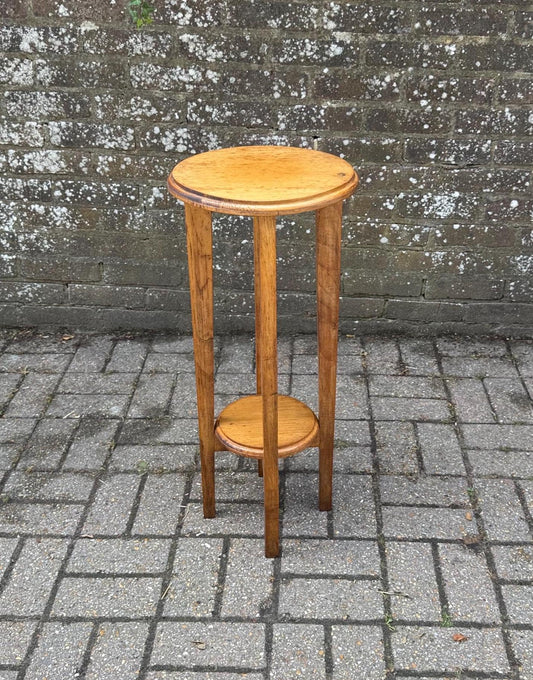 quality pine plant stand with two tiers. lovely shaped tapered legs. golden yellow colour. likely 1980s