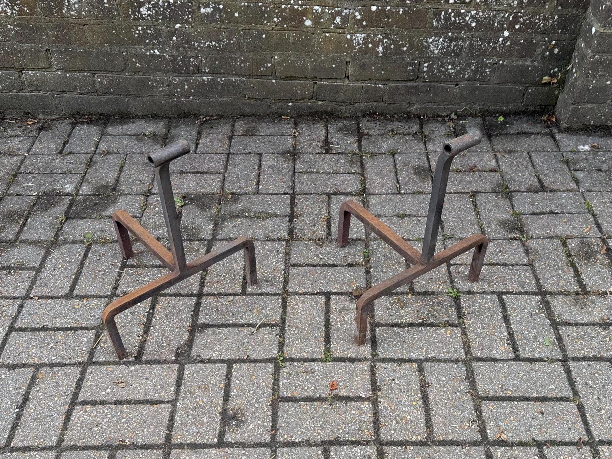 wrought iron fire dogs - unique mid century shape. rusted finish. heavy iron accessories for fireplace