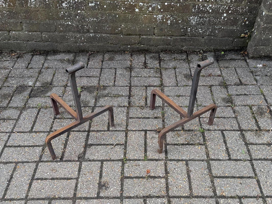 wrought iron fire dogs - unique mid century shape. rusted finish. heavy iron accessories for fireplace