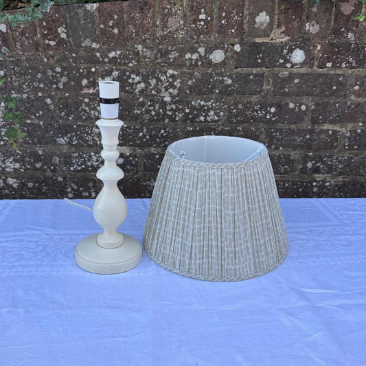 painted wooden lamp with lovely turned column and round base. comes with neutral coloured cotton lined shade with geometric pattern. clean and tidy.