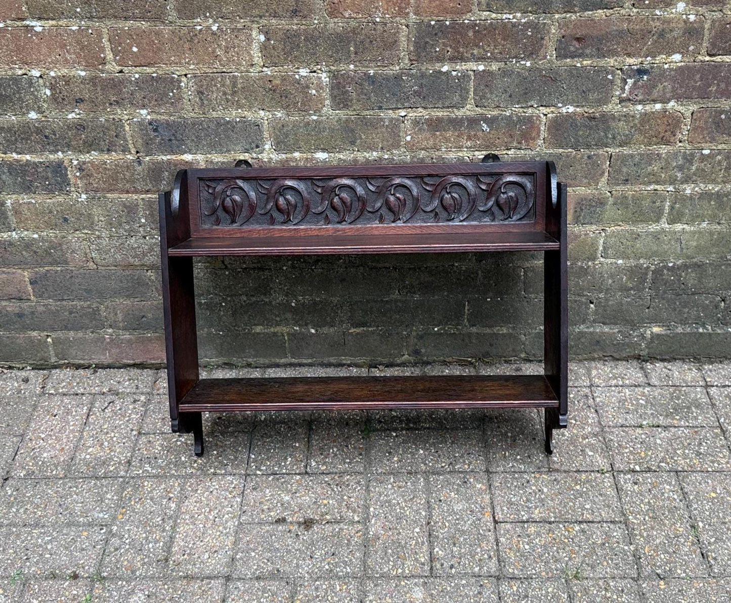 antique oak shelf, dark wood shelf with tulip motif. arts and crafts, art nouveau style. delicate carving in the oak shelf