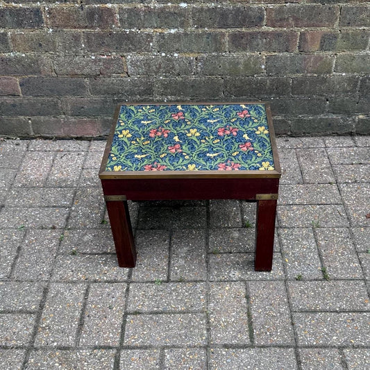 vintage wooden table in dark hardwood and brass. Glass table top with william morris material underside. plant stand or side table